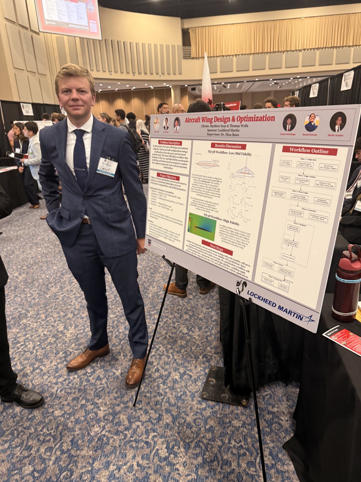 RJ at the capstone showcase in front of the Lockheed Martin project poster.